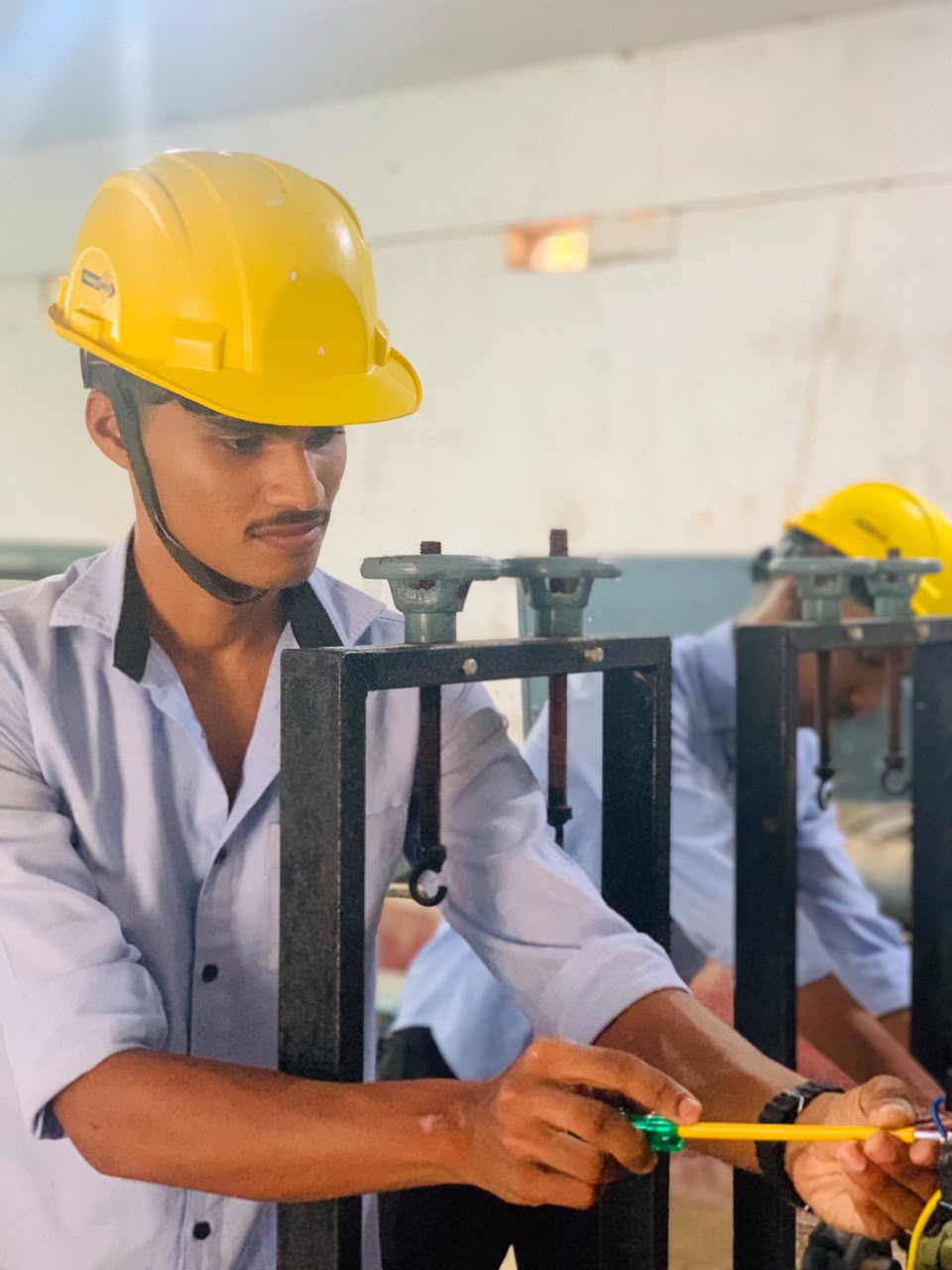 Student in electrical lab with hard hat