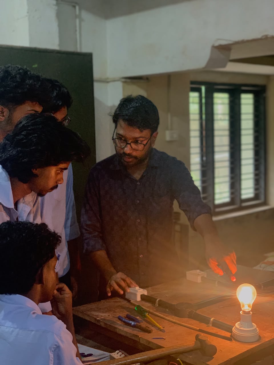 Faculty teaching students in practical lab